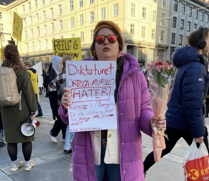 Imagen de Saballos durante una manifestación el 8 de marzo de 2024. En el cartel se lee en noruego: “La dictadura Ortega-Murillo ODIA alas mujeres en Nicaragua. Nos golpean, violan y asesinan. Noruega: ¡No nos olvidés!”. Foto: Cortesía